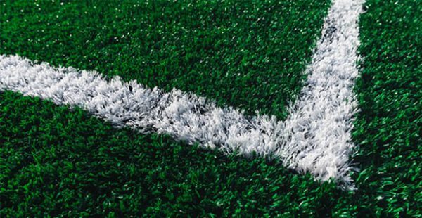 Artificial turf sports field with a white line